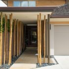 Modern entrance with bamboo accents and a garage door.